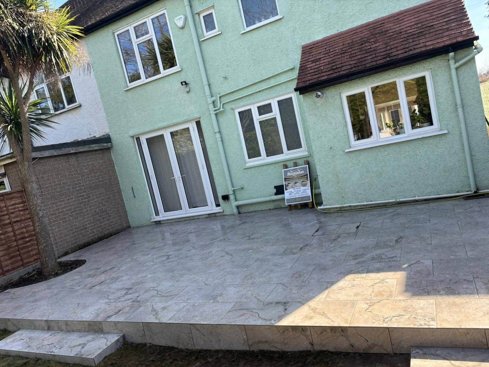 Large marble-effect porcelain patio with step detail